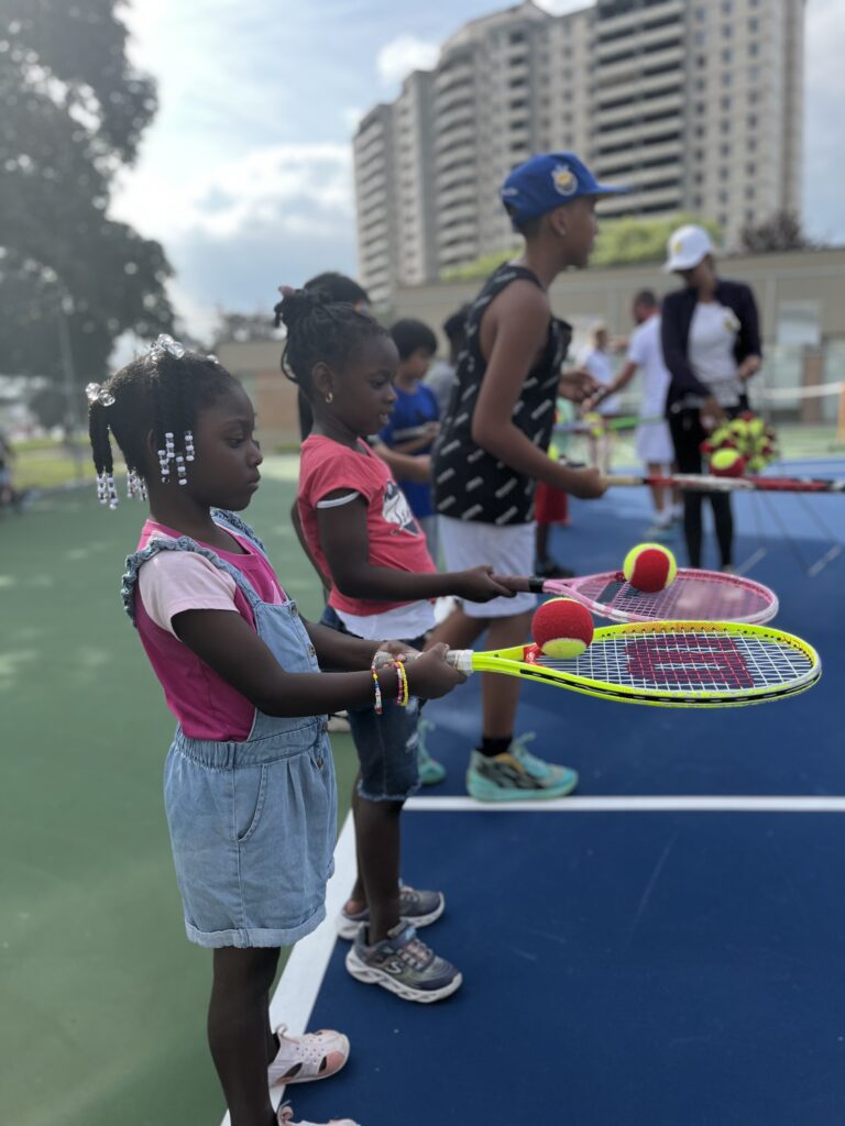 Children learn how to dribble the tennis ball on their racket